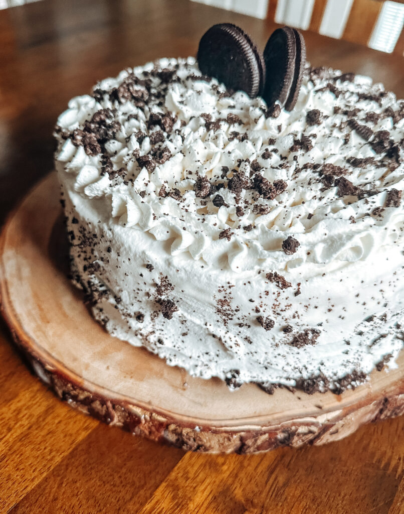 oreo ice cream cake with whipped cream and hot fudge