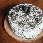 gluten free oreo ice cream cake with whipped cream and hot fudge