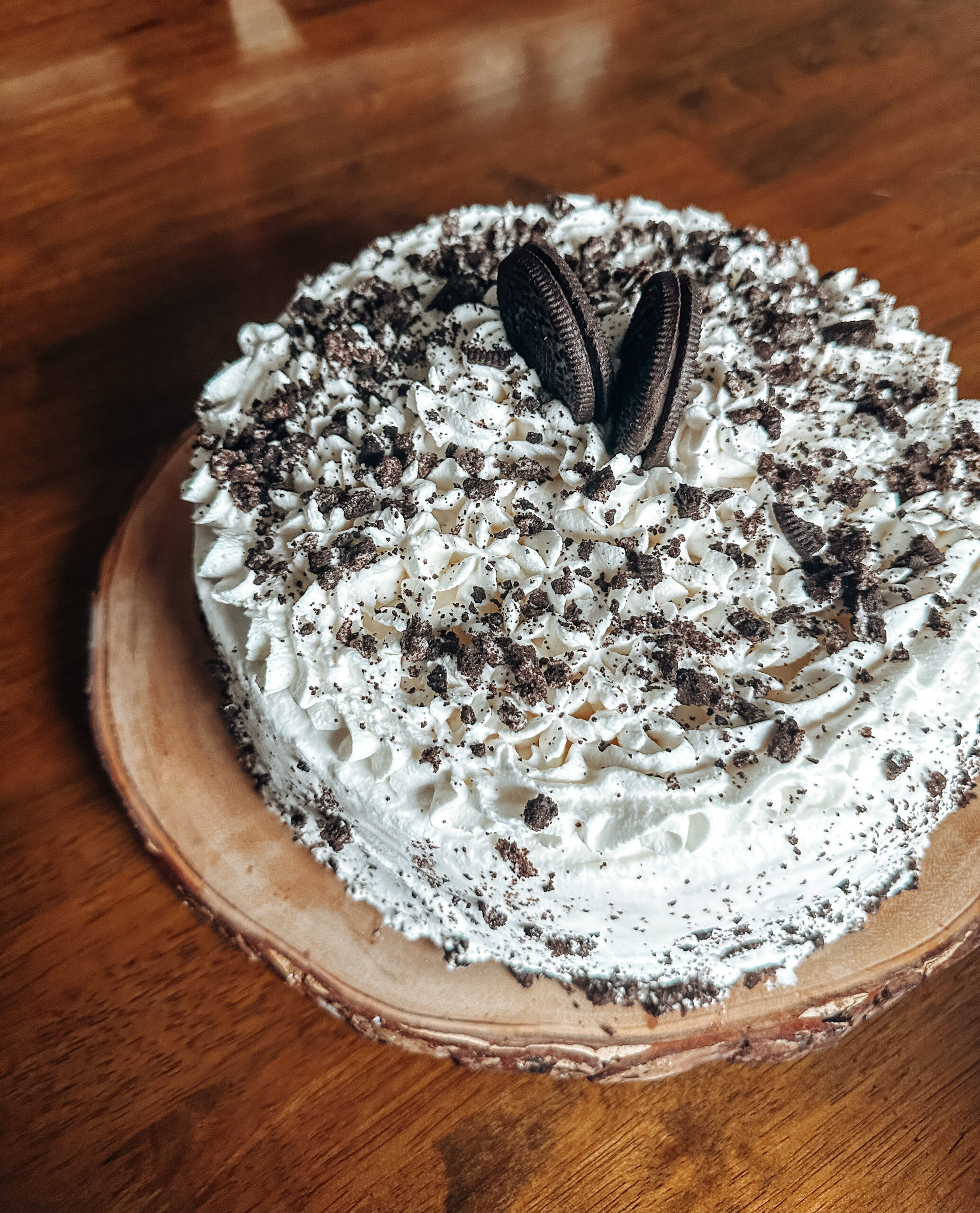 gluten free oreo ice cream cake with whipped cream and hot fudge